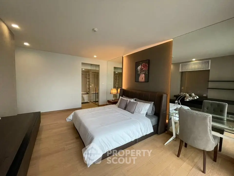 Spacious modern bedroom with elegant decor and natural lighting