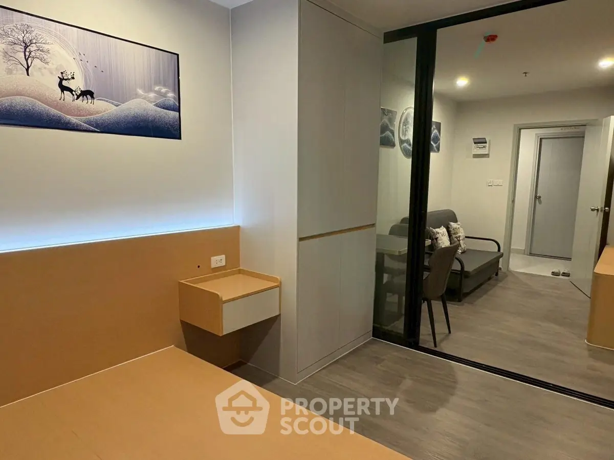 Modern apartment interior with sleek design and stylish decor, featuring a cozy living area and elegant artwork.