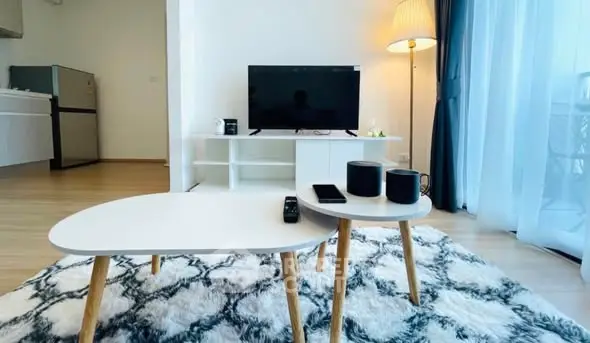 Modern living room with stylish furniture and entertainment setup.