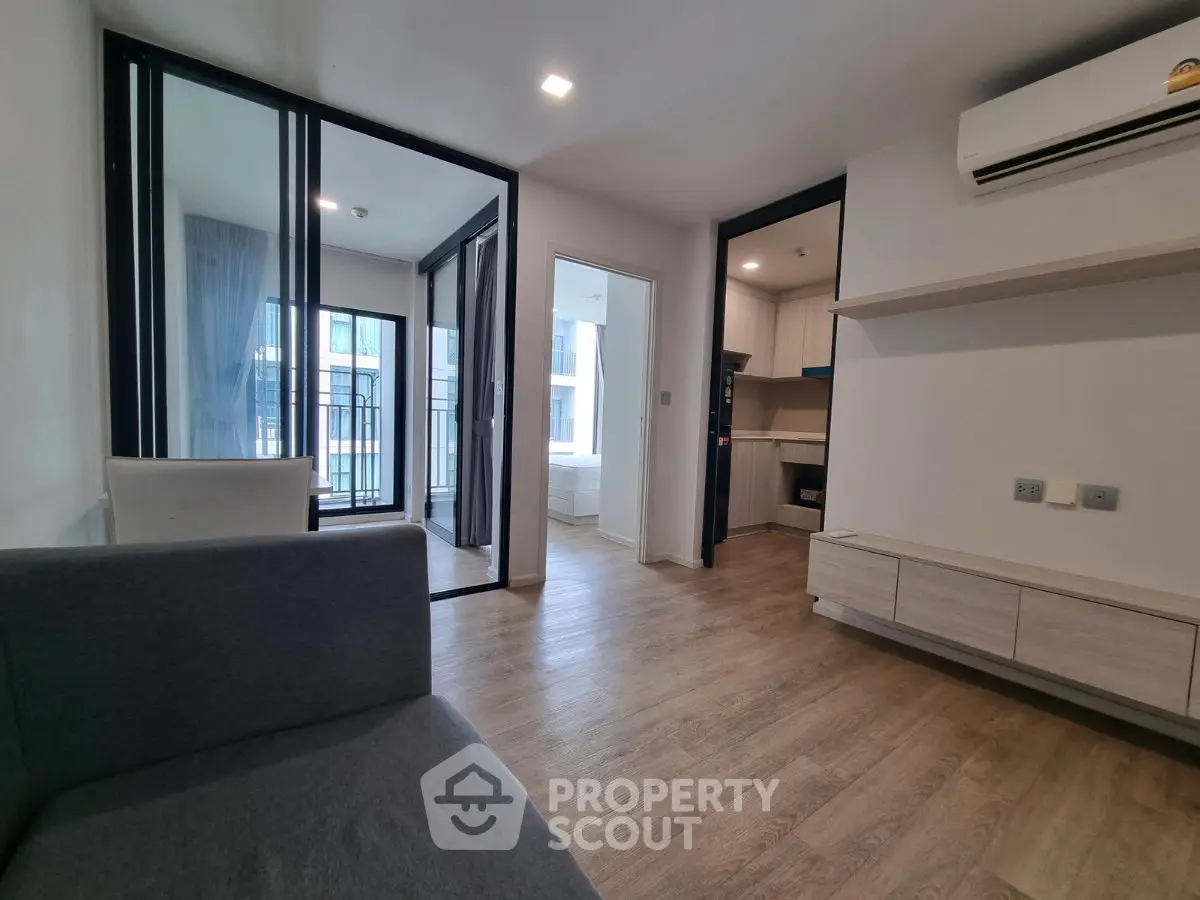 Modern apartment interior with open layout and balcony view