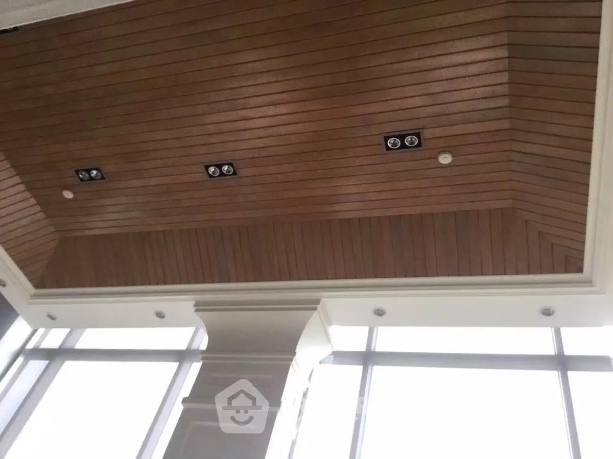 Elegant wooden ceiling with recessed lighting in a modern building interior