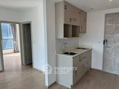 Modern compact kitchen with sleek cabinetry and open layout in a bright apartment.
