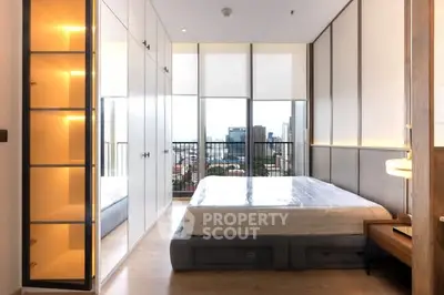 Modern bedroom with floor-to-ceiling windows and city view