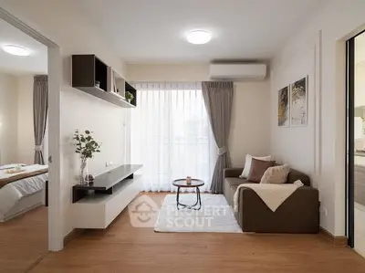 Modern living room with cozy sofa, stylish decor, and natural light from large window.