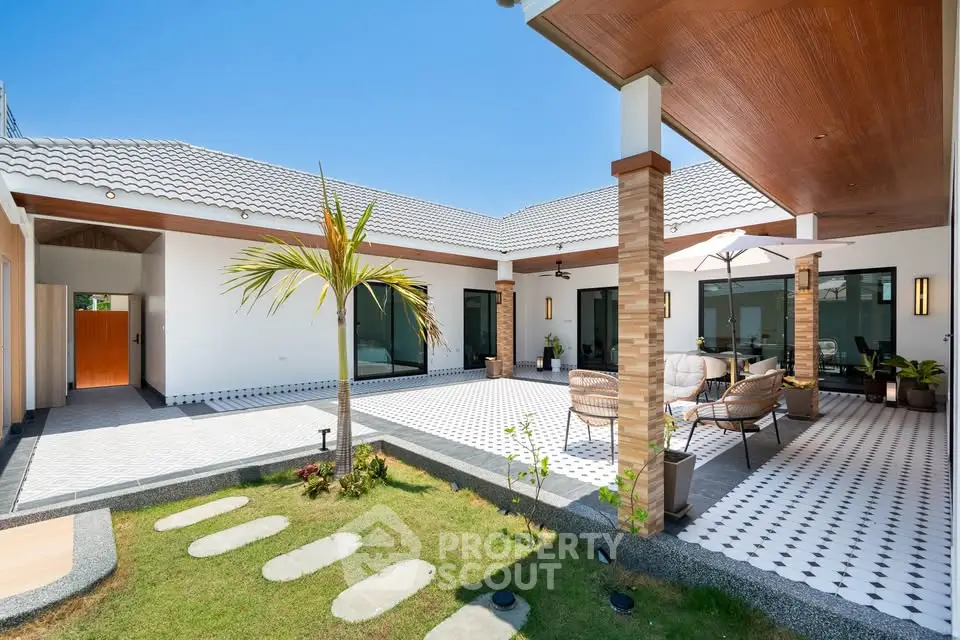 Stunning modern courtyard home with spacious patio and lush garden, perfect for outdoor living.