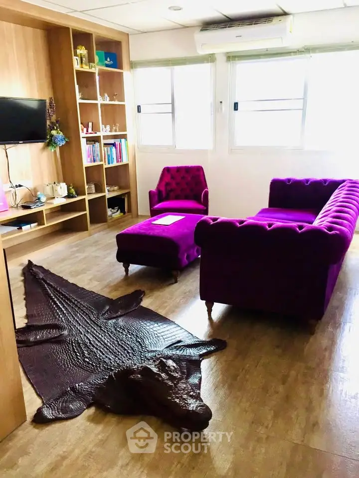 Stylish living room with vibrant purple furniture and unique crocodile rug