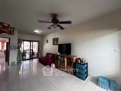 Spacious living room with ceiling fan and modern furniture, perfect for family gatherings.