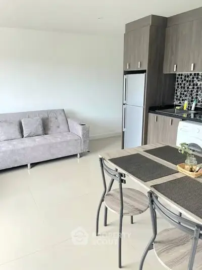 Modern open-plan living room with sleek kitchen and dining area