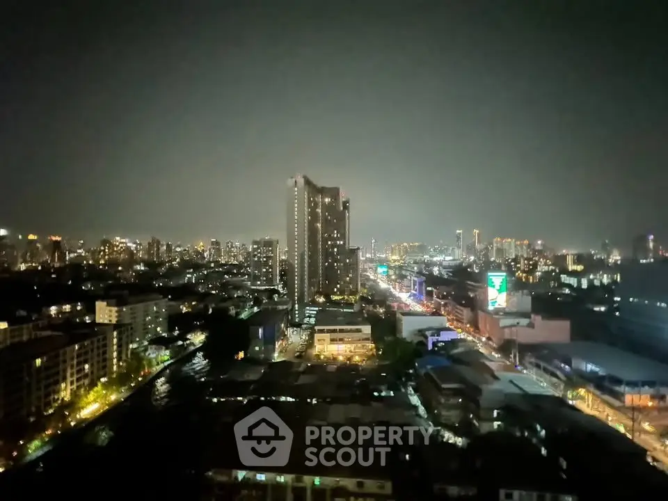 Stunning cityscape view from high-rise building at night with vibrant city lights.