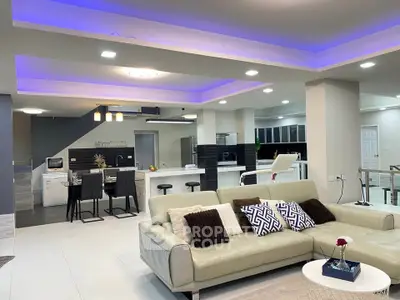 Luxurious open-plan living room with modern kitchen and stylish lighting
