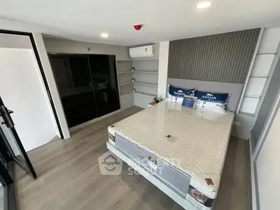 Modern bedroom with sleek design and ample storage space in a contemporary apartment.