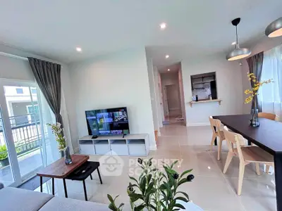 Modern living room with open layout, stylish dining area, and natural light