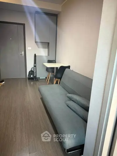 Modern living room with sleek sofa and compact dining area