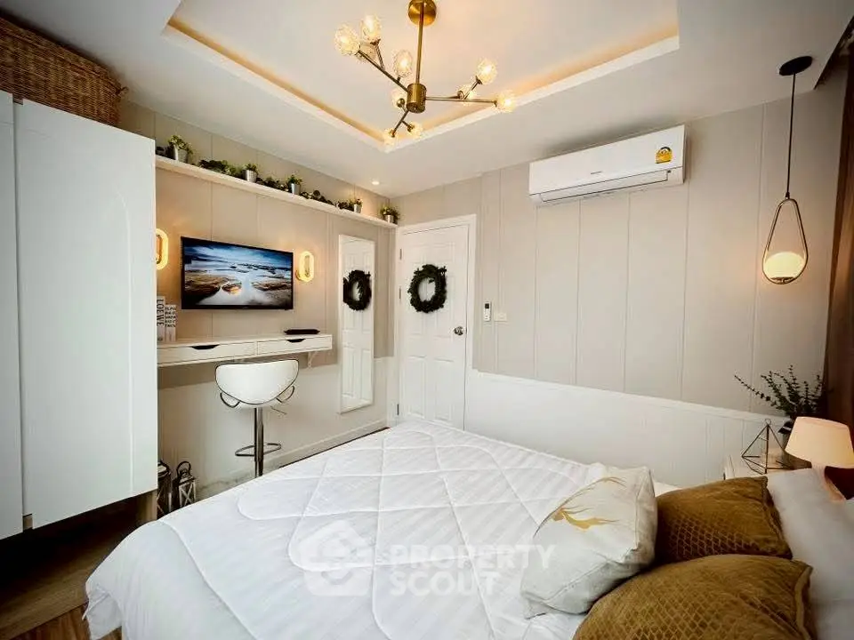 Stylish bedroom with modern decor and cozy ambiance, featuring a wall-mounted TV and elegant lighting.