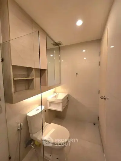Modern bathroom with sleek fixtures and ambient lighting in a contemporary apartment.