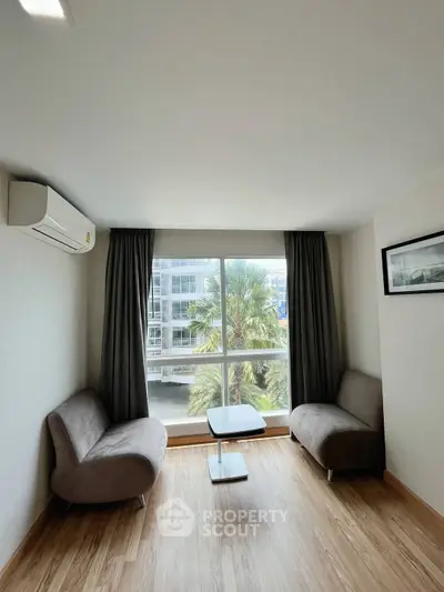 Bright living room with modern sofas and large window view