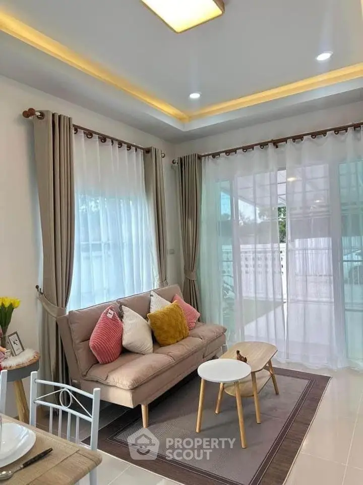 Charming living room with cozy sofa and elegant curtains in bright natural light