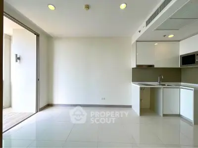 Modern kitchen with sleek white cabinetry and open layout in a bright apartment.