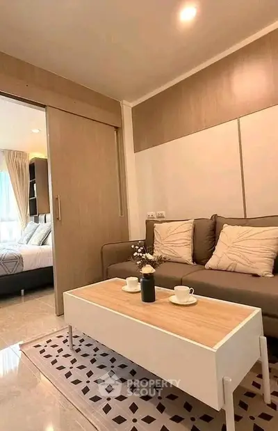 Modern living room with cozy sofa and stylish coffee table in a well-lit apartment.