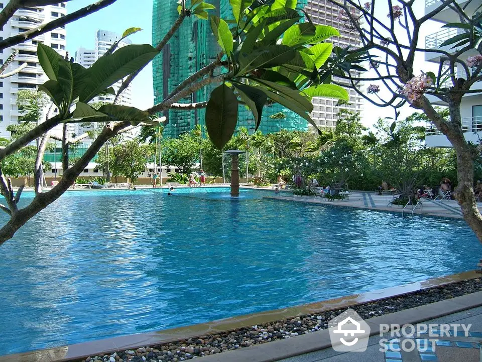 Luxurious outdoor pool with lush greenery in urban residential complex