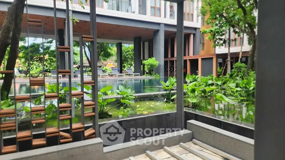 Luxurious garden view with serene water features in modern architectural setting.