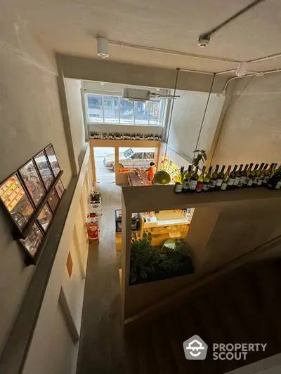 Modern interior view of a stylish wine bar with contemporary decor and staircase.