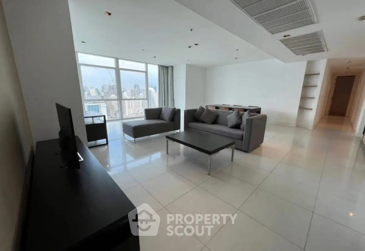 Spacious modern living room with city view and sleek furniture