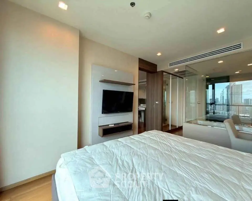 Modern bedroom with city view, featuring sleek design and integrated TV unit, perfect for urban living.