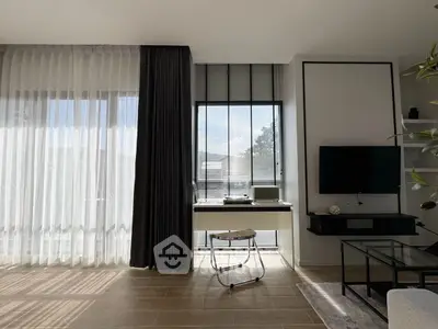 Modern living room with floor-to-ceiling windows and stylish decor