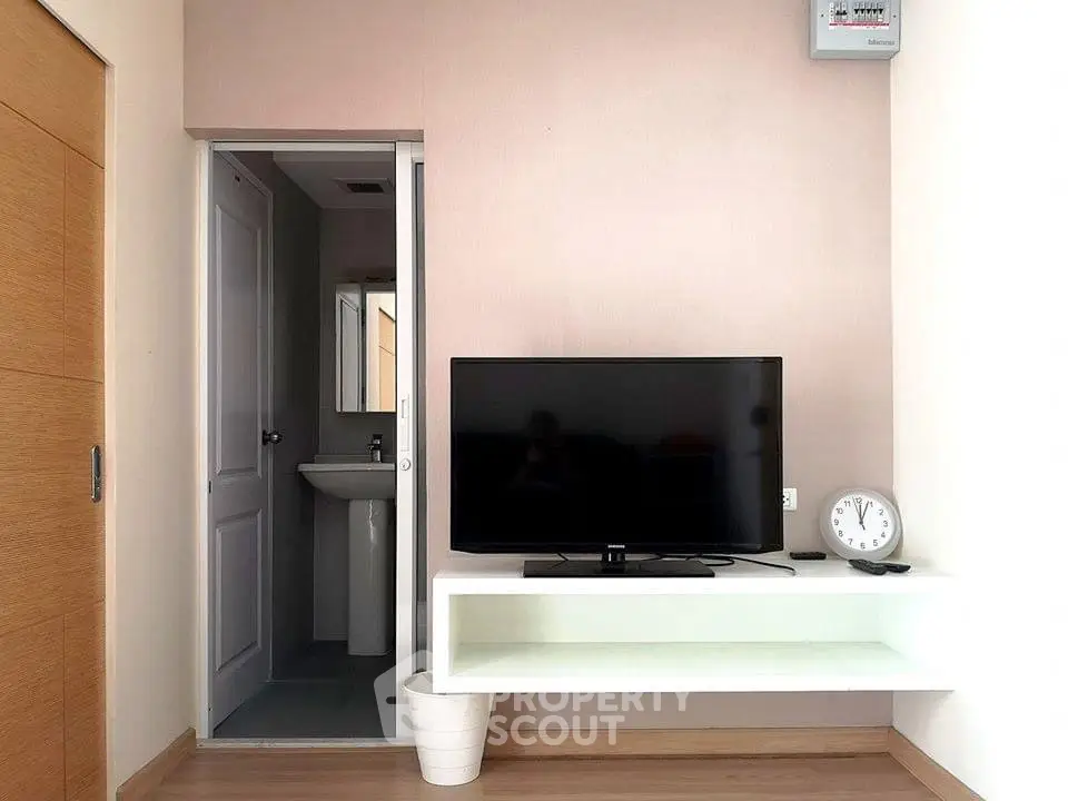 Modern living room with wall-mounted TV and minimalist decor
