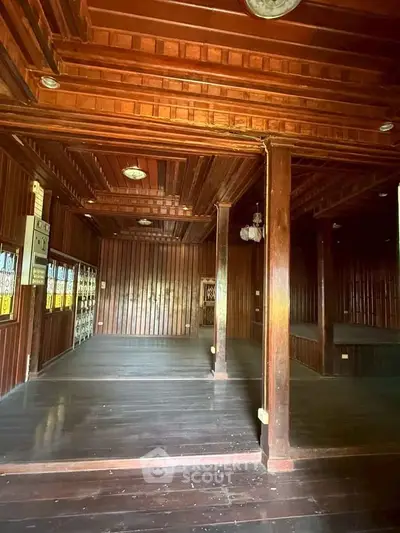 Charming wooden interior with rustic beams and open space, perfect for a cozy living area or creative studio.