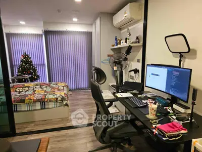 Modern studio apartment with workspace and cozy bedroom, featuring air conditioning and stylish decor.