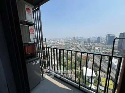 Stunning cityscape view from a high-rise balcony with modern railing.