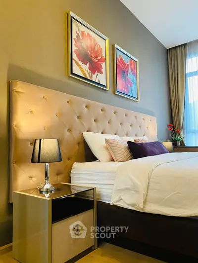 Luxurious bedroom with elegant decor and plush headboard, perfect for relaxation and comfort.
