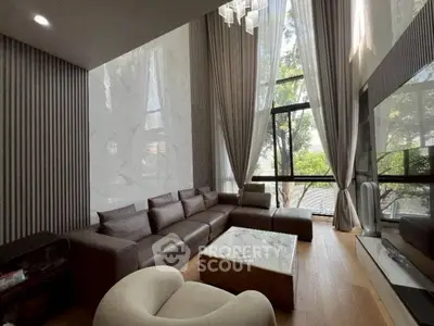 Luxurious modern living room with high ceilings and large windows