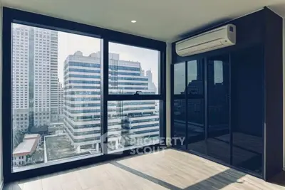 Modern high-rise apartment with floor-to-ceiling windows and city view, featuring sleek built-in storage and air conditioning.