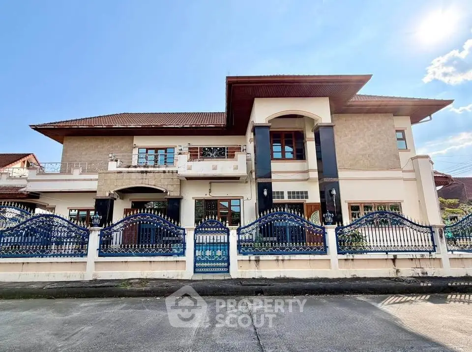 Stunning two-story house with elegant facade and decorative fencing in a serene neighborhood.