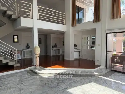 Spacious modern living room with high ceilings and elegant marble flooring