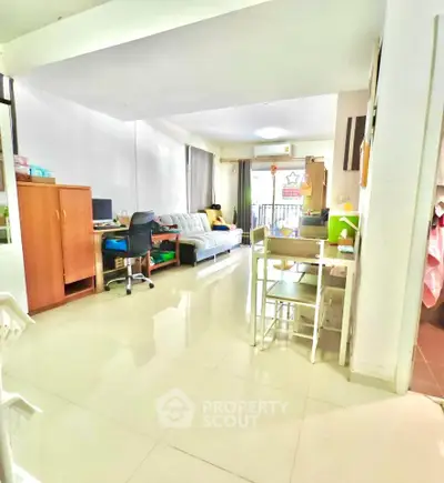 Spacious living room with modern decor and natural light, perfect for relaxation and entertaining.