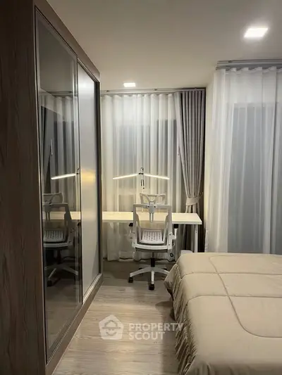 Modern bedroom with study area, featuring sleek furniture and soft lighting for a cozy ambiance.
