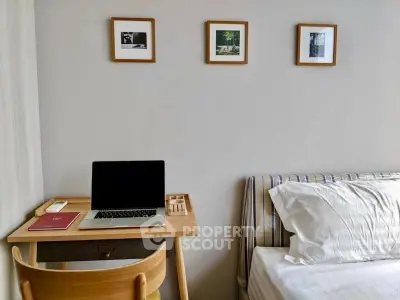 Cozy bedroom with study desk and stylish decor, perfect for modern living.