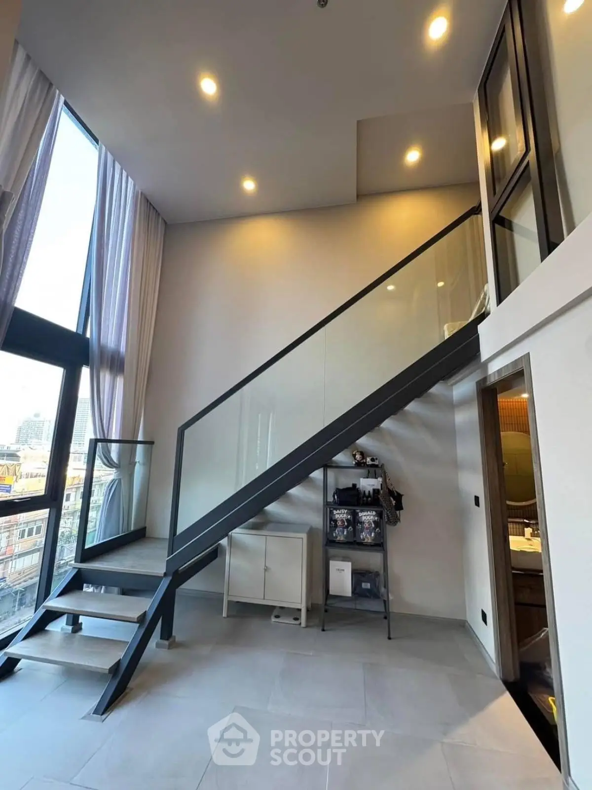 Modern loft apartment with high ceilings and sleek staircase