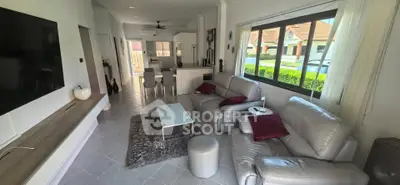 Spacious living room with modern decor and large windows in a stylish home