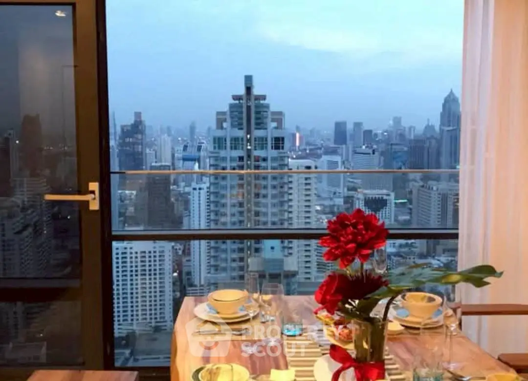 Stunning city view from a high-rise apartment dining area with elegant table setting.