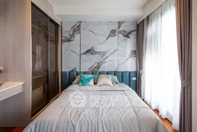 Luxurious bedroom with marble accent wall and large windows