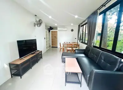 Spacious living room with modern furniture and large windows offering natural light.