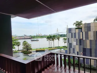 Stunning river view from a modern balcony with lush greenery and architectural elegance.