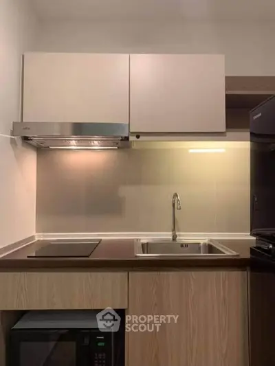 Modern kitchen with sleek cabinetry, built-in appliances, and stylish lighting.