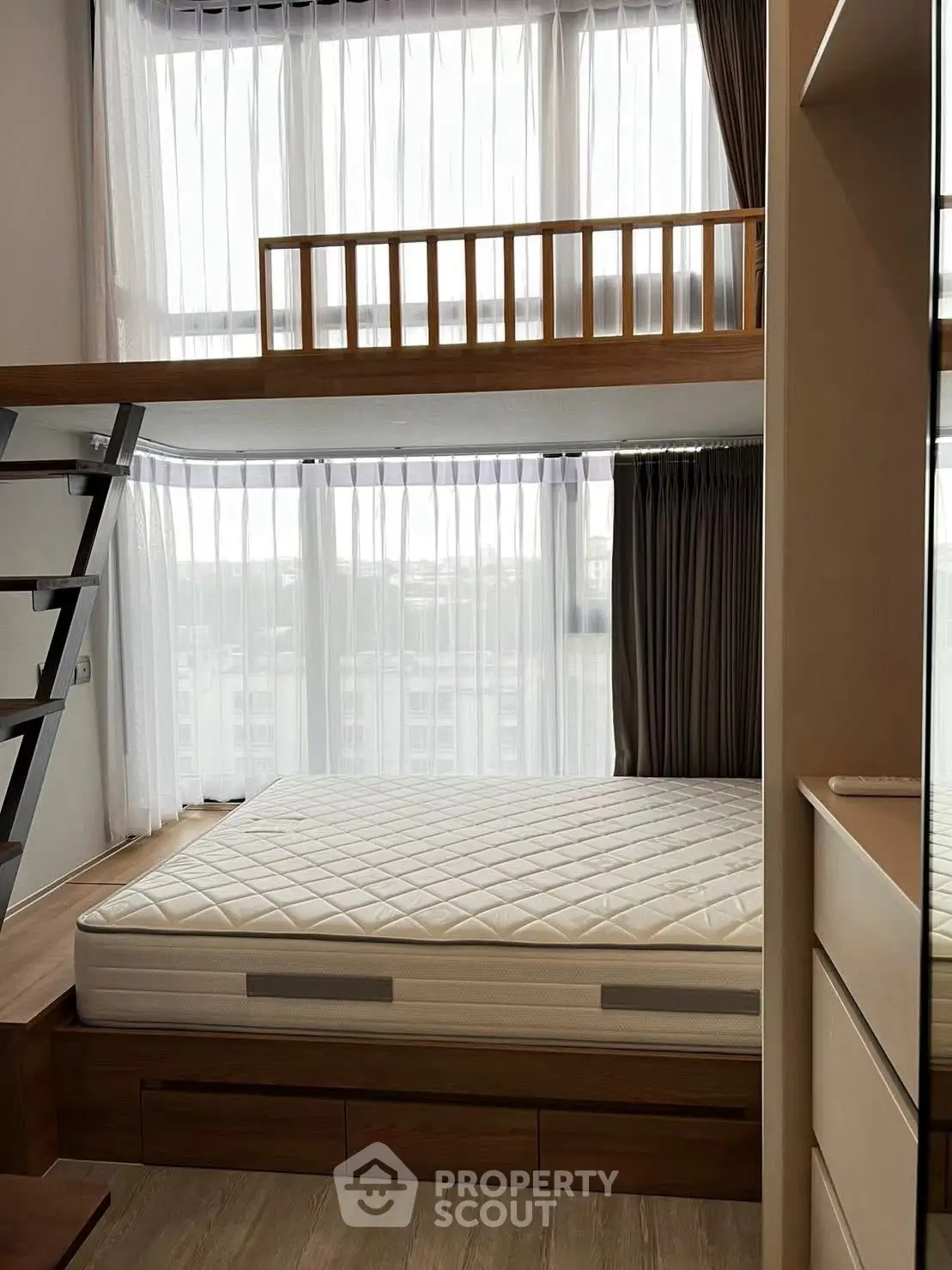 Modern loft bedroom with large windows and stylish wooden accents