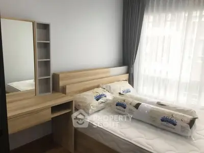 Cozy bedroom with natural light and modern wooden furniture